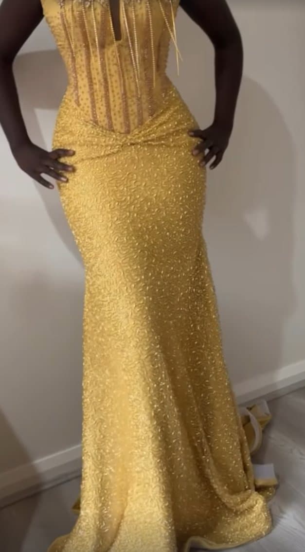 Full-length gold beaded gown on model